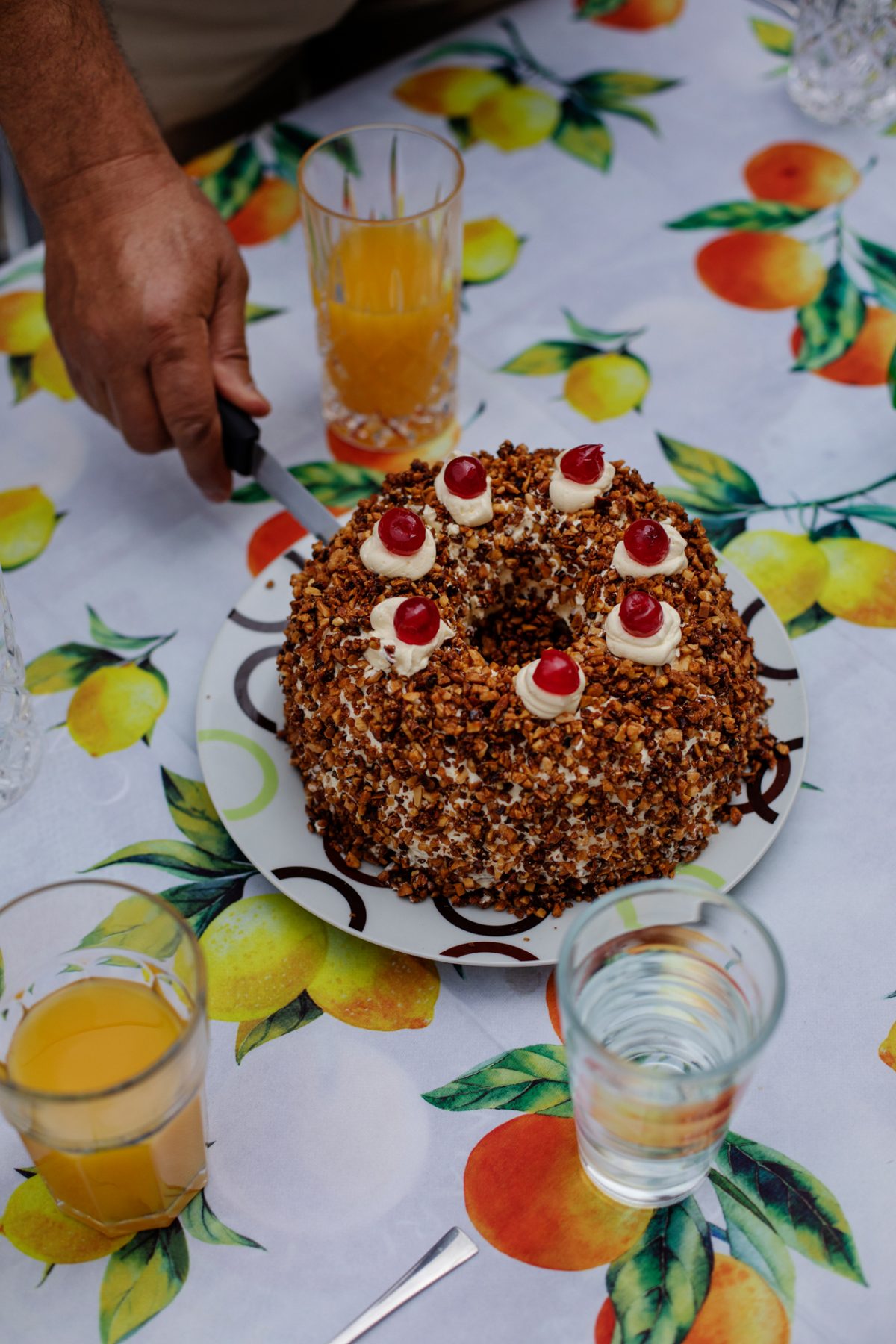 Jemand schneidet einen Frankfurter Kranz an.