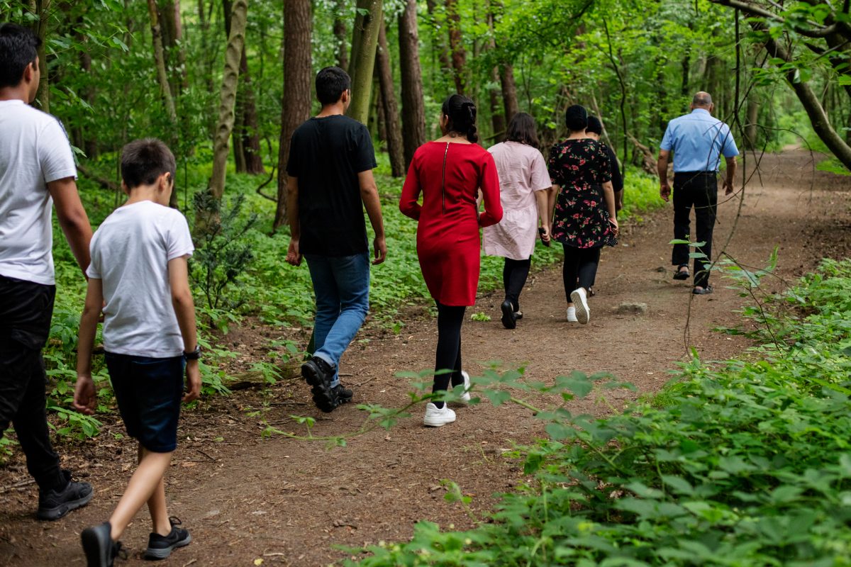 Eine Großfamilie macht einen Spaziergang durch den Wald.